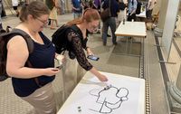Teachers engaging with ZHAWs Grove Zero robot